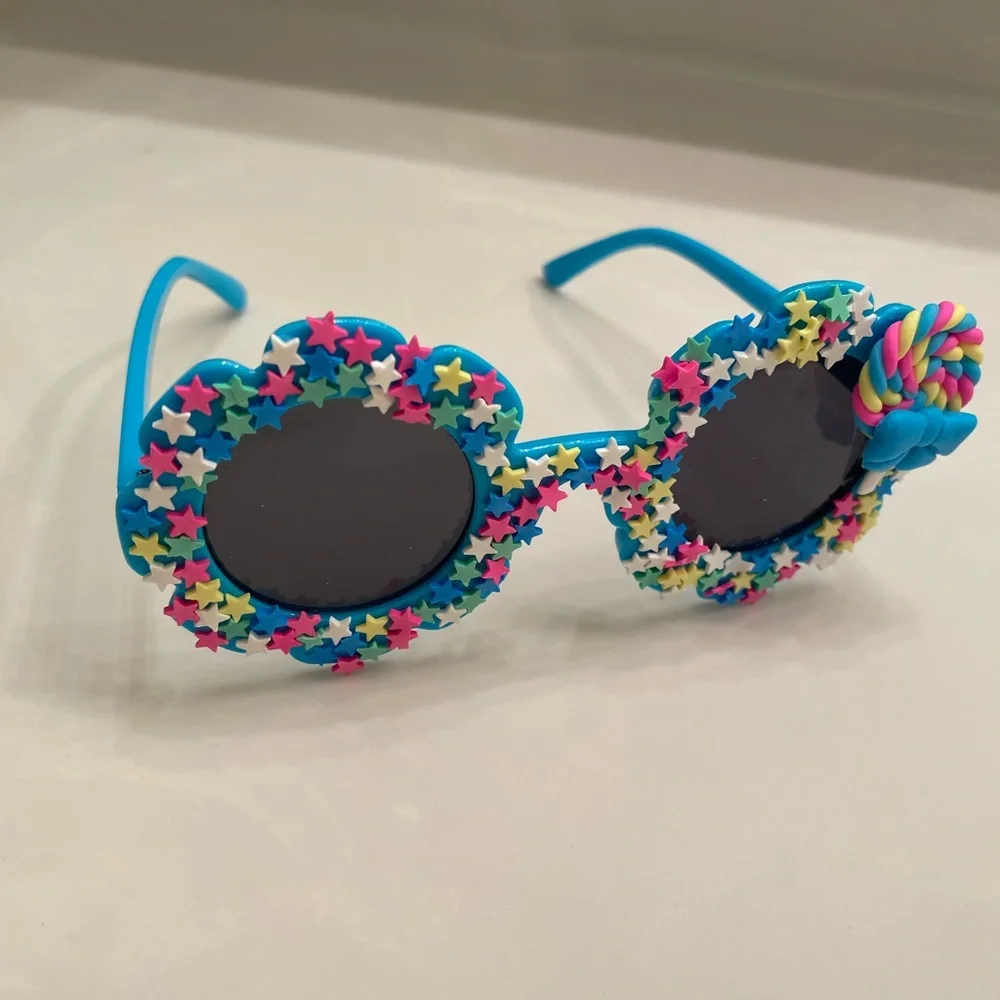 Girls electric blue flower shaped sunglasses